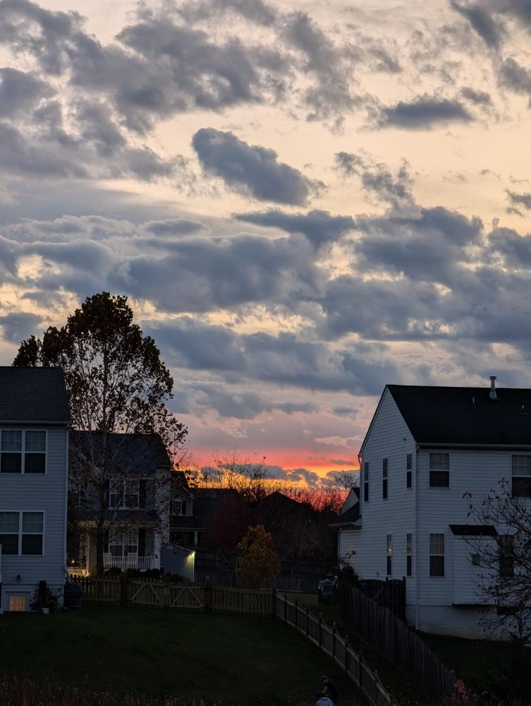 Bright orange sunset between the houses