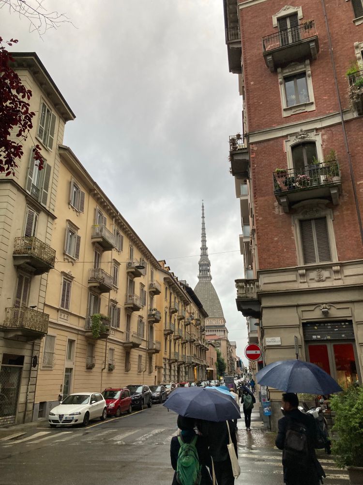 A street scene in Turin with the Mole Antonelliana tower in the background 