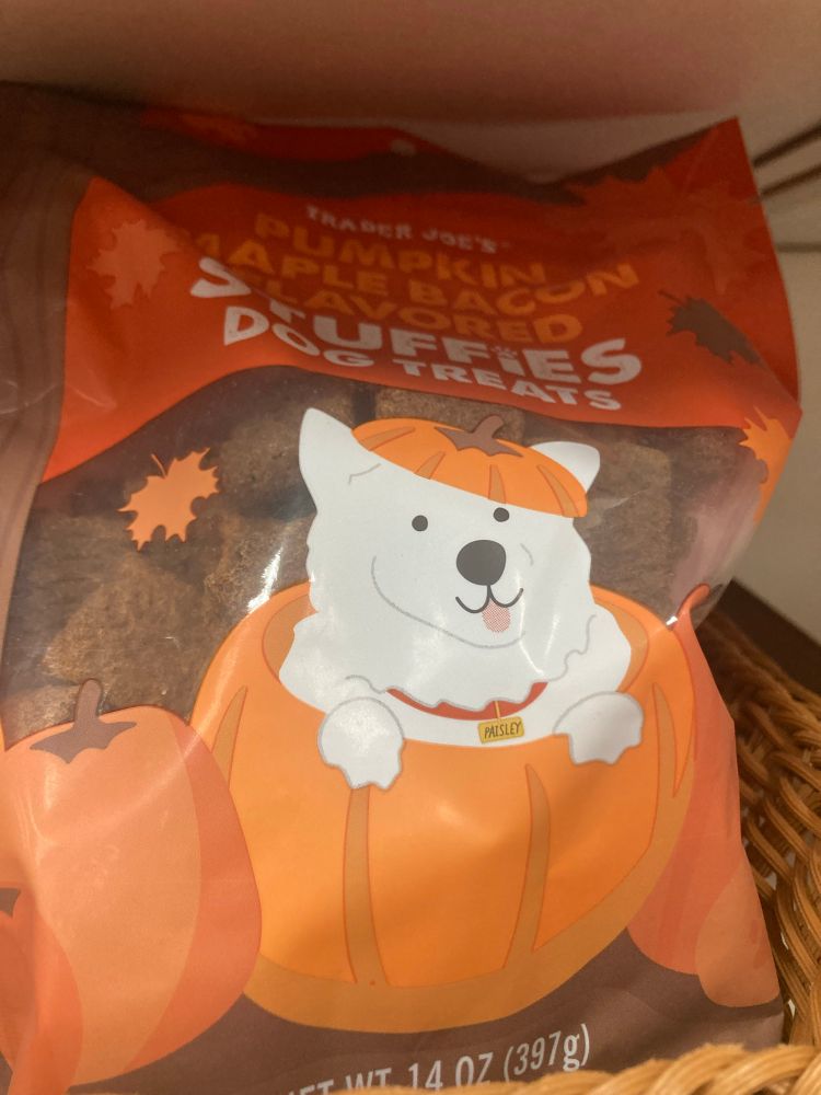 Dog treat with dog peeking out of a pumpkin on its packaging