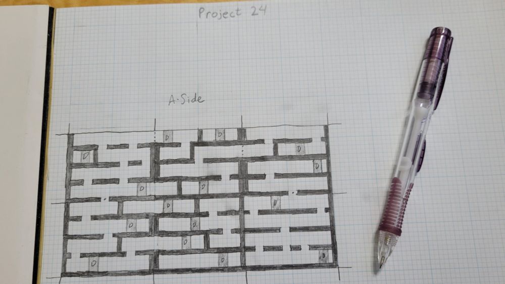 Graph paper with a maze-like drawing on it. At the top says "Project 24". Next to the drawing is a purple mechanical pencil