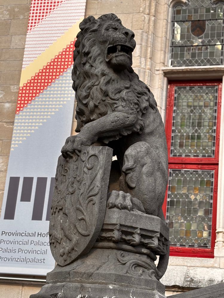 Stone sculpture of lion holding a shield