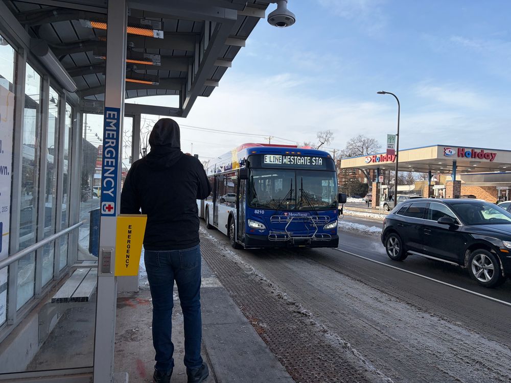 E Line bus pulling up to a station on Hennepin Ave in the Wedge