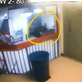 Zoomed in screenshot of the Epstein camera video at 11:58 with a highlight of a shadowed area that disappears after the video cut 