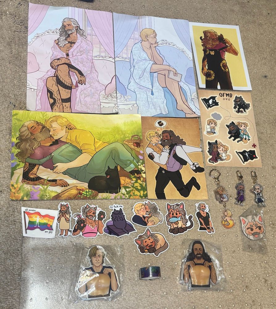 Several prints of Ed and Stede, Kitty Ed stickers, and Kitty/puppy Ed and Stede sticker sheet, plus fisherman Ed merstede charm, all by Tuka. Plus! Squishy tiddy Ed and Stede, some washi tape, and Sir Goddfrey and Jeff charms. 