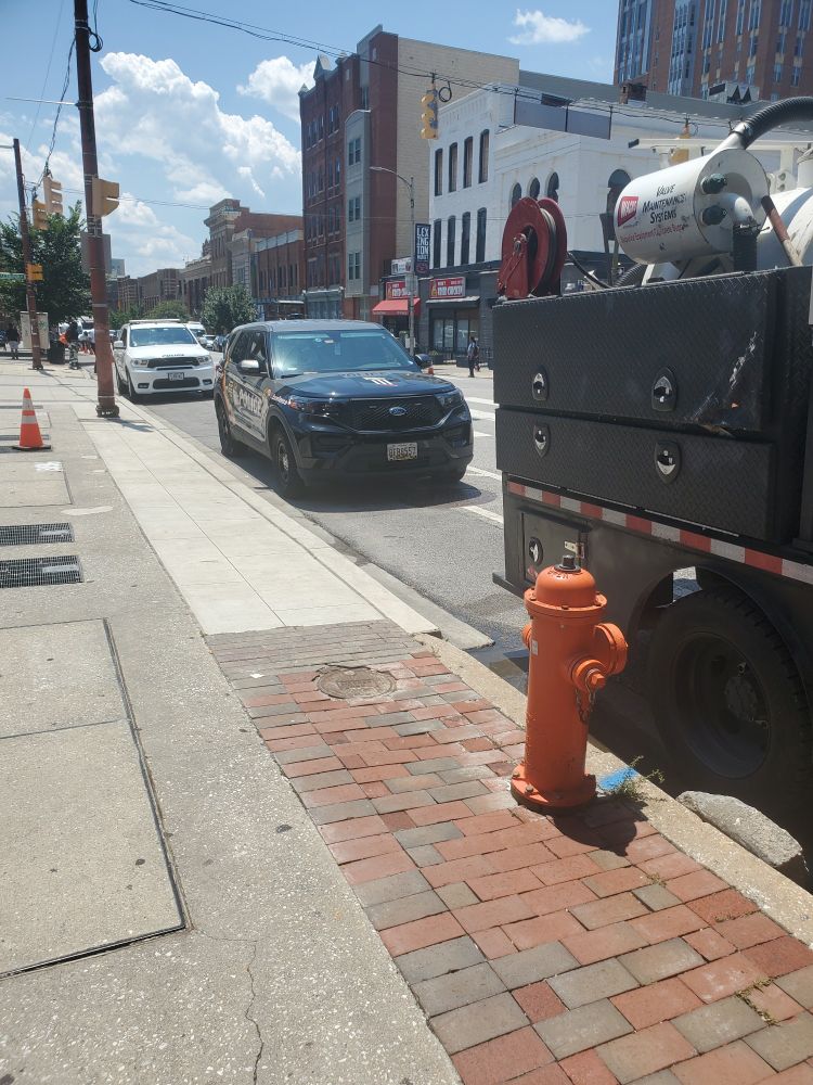 UMD Police blocking cycle lane to get lunch, while another vehicle blocks access to a fire hydrant.