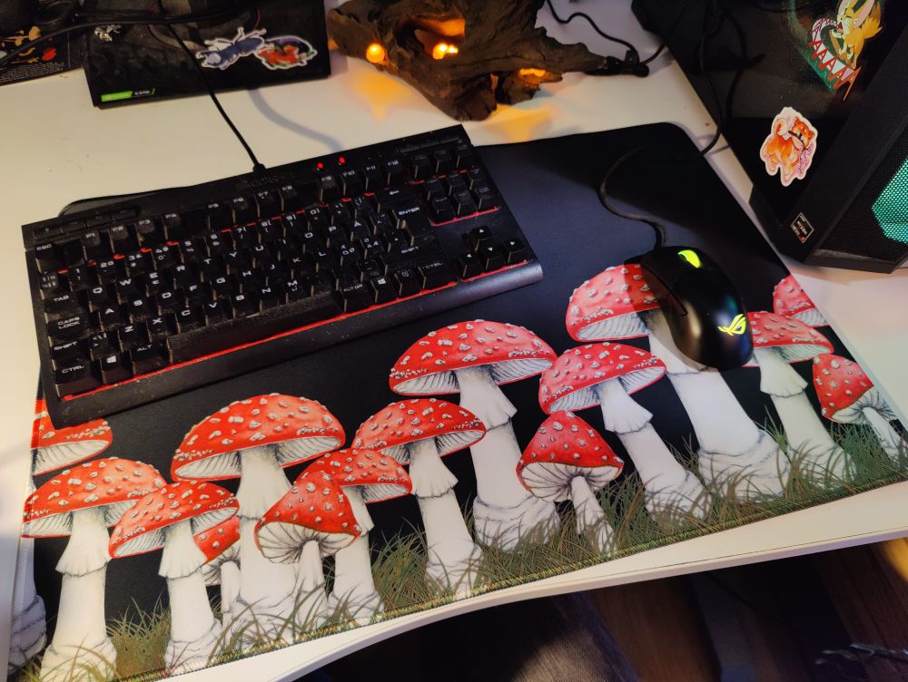 Large black mousepad with Fly Amanita mushrooms on it