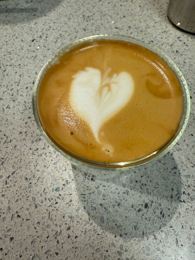 A Cortado with art in the form of a slightly wonky heart. 