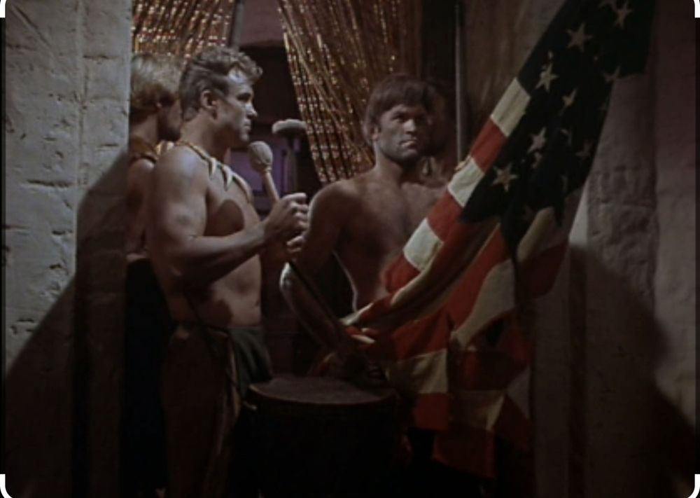 Screencap from The Omega Glory Star Trek episode. Where on the distant planet crew of the Enterprise finds a society that uses an American flag and constitution. 