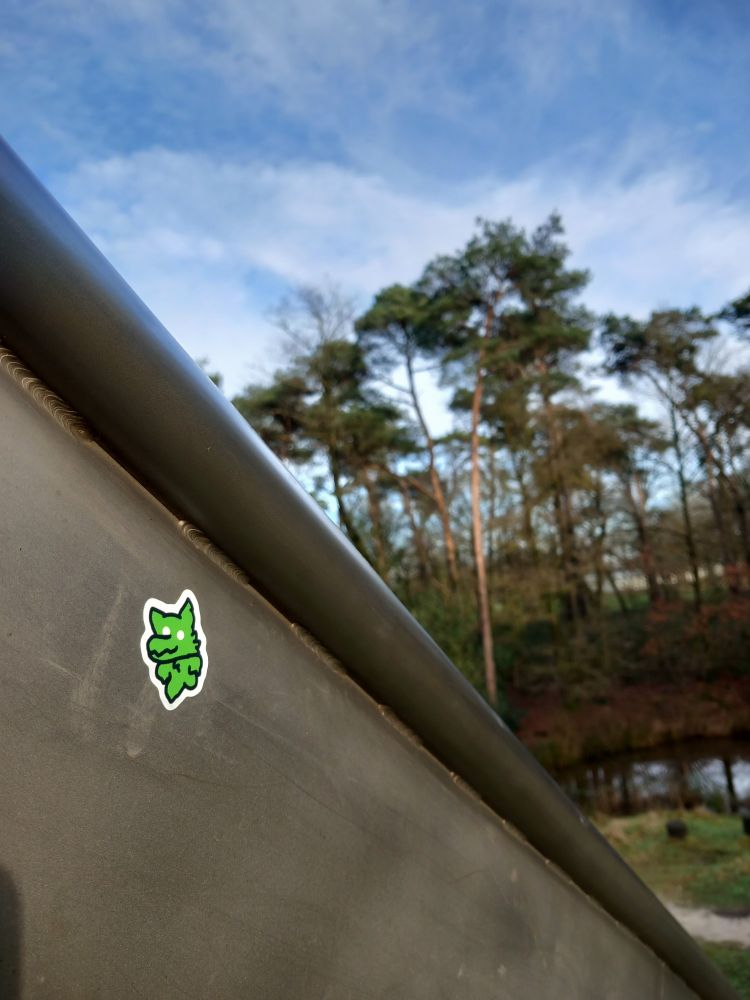 A sticker of a green goopy motherfucker on the side of a slide representing my descent into madness :3