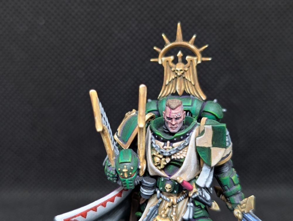 Dark Angels Master Lazarus from Games Workshop. 

His armour is dark green, the inside of his cloak is white with red trim. His sword is Non-metalic silver and the trim of his armour is non-metalic gold. 

Painted by me. 