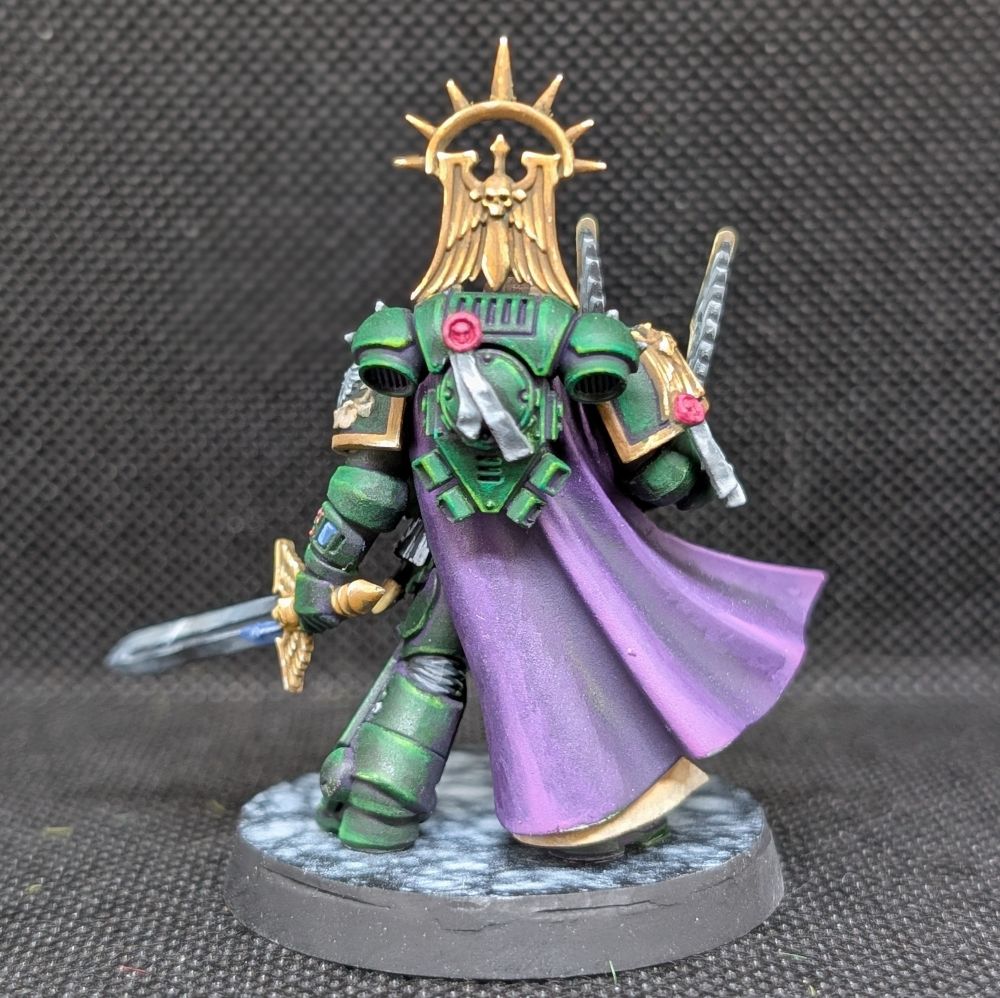 Back view.

Dark Angels Master Lazarus from Games Workshop. 

His armour is dark green, the inside of his cloak is white with red trim. His sword is Non-metalic silver and the trim of his armour is non-metalic gold. His cape is purple.

Painted by me. 