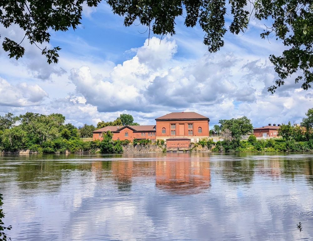 An old brick building and clouds reflecting in the Mississippi River