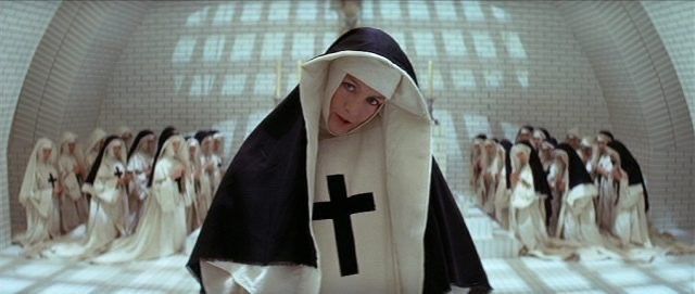 Still from The Devils (1971): nuns in a pale, starkly lit tile room.