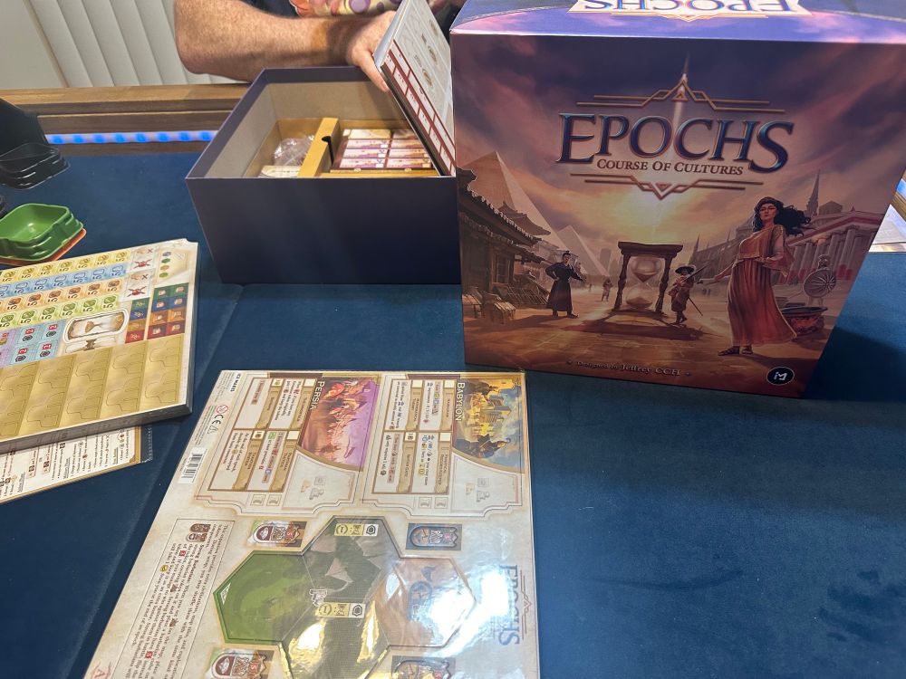 Epochs Course of Cultures game box. Shrink wrapped cardboard bits that need to be punched out are next to the box.