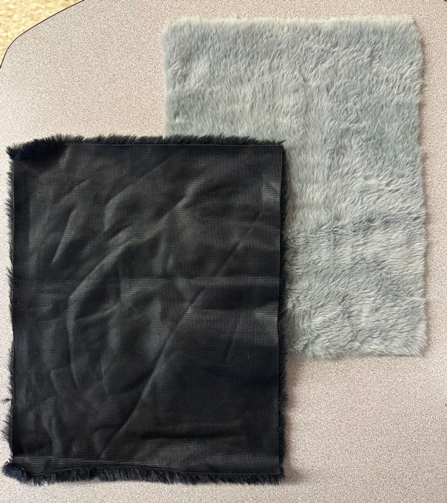 Black and gray rectangular swatches of faux fur fabric.