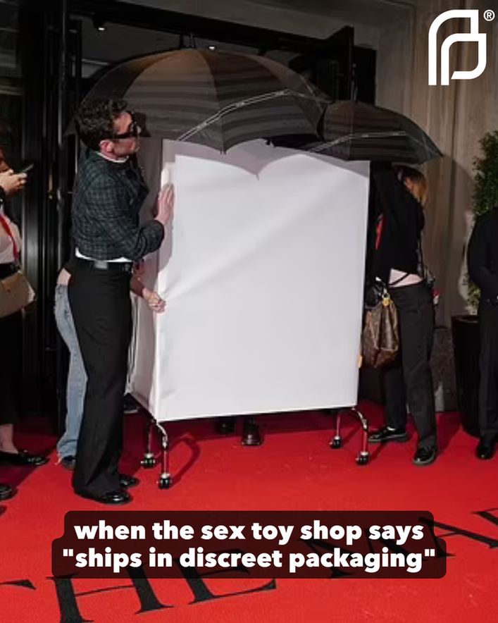 Photo of Doechii hiding in a box concealed by people and umbrellas on the Met Gala red carpet. Text reads: when the sex toy shop says "ships in discreet packaging"