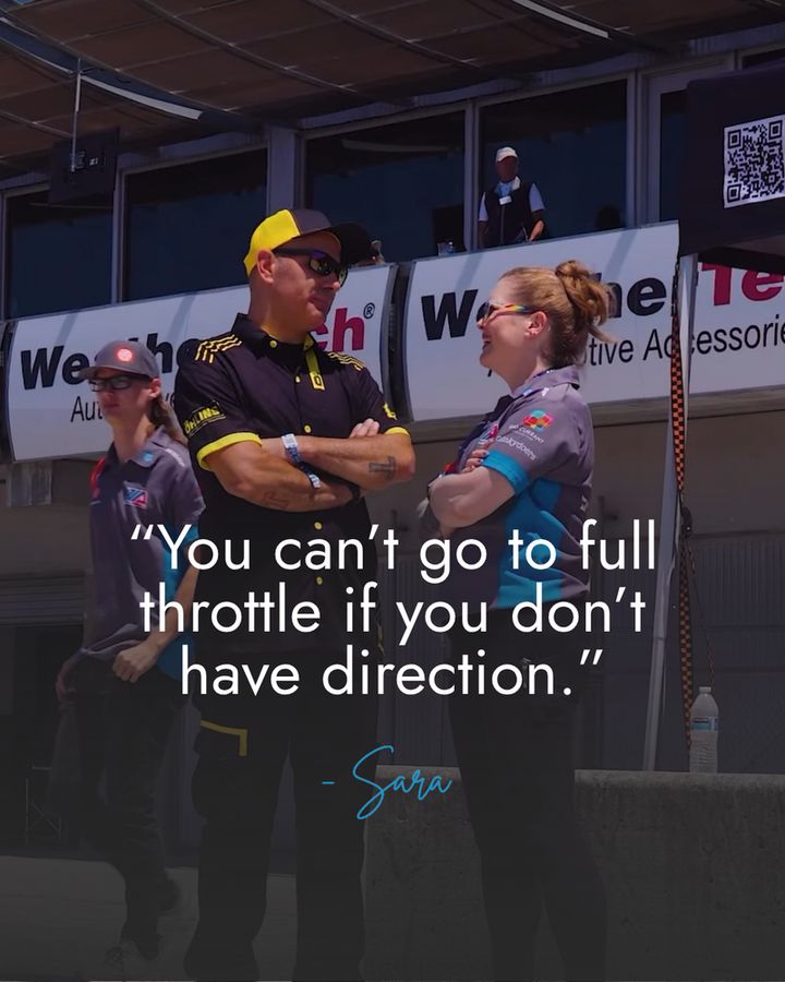 I'm standing on hot pit at Laguna Seca Raceway, with my friend Niko. I'm wearing my grey and blue CW Moto team shirt, and he's also in his team gear. We're both standing with our arms crossed talking. The copy over the image is:

"You can't go to full throttle if you don't have direction."