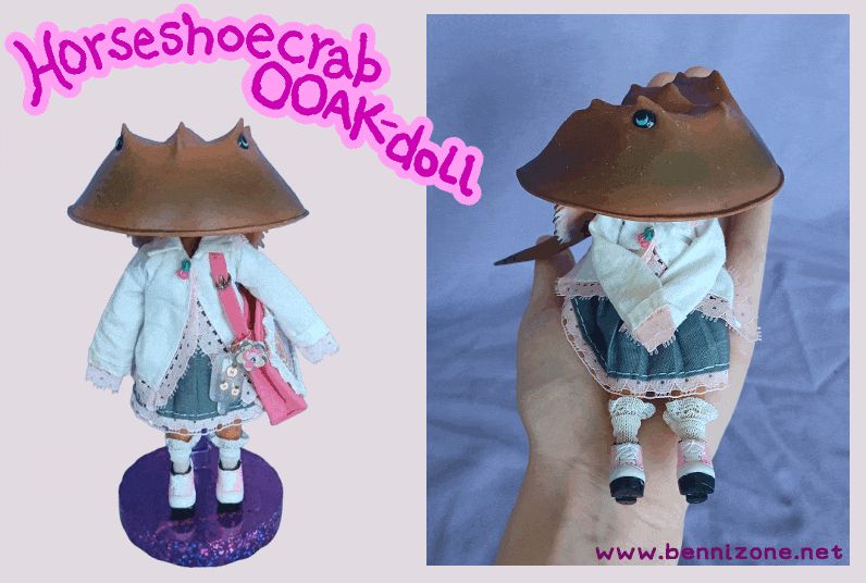 A doll, customized to have the head of a horseshoe crab; that is, the shell of one. She is otherwise humanoid, in cutesy fashion.