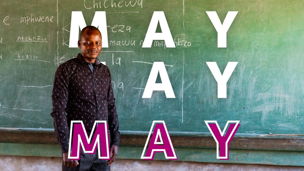 Person standing in front of a chalkboard in a classroom setting. On top of this image, text overlays with the word "MAY" three times in large letters. The first two words are in white, while the third word is purple.