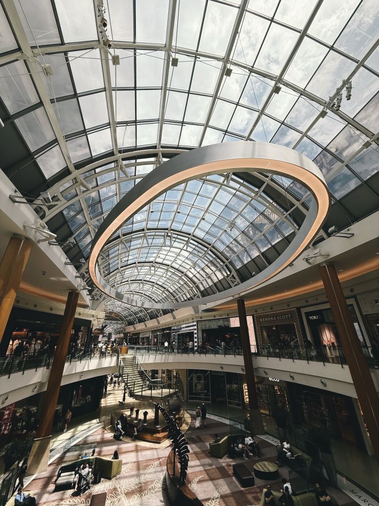 Wide angle shot inside Millennial Mall at Orlando, FL showcasing its beautiful glass ceiling.