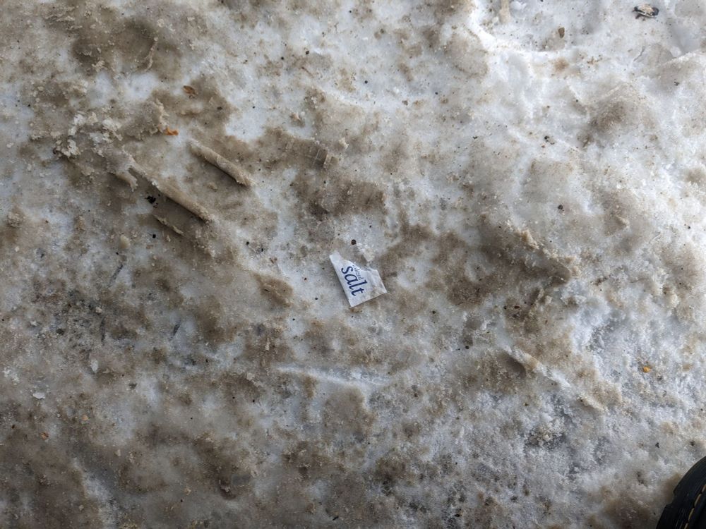An emptied salt packet on about 2 inches of packed ice.  Futility.