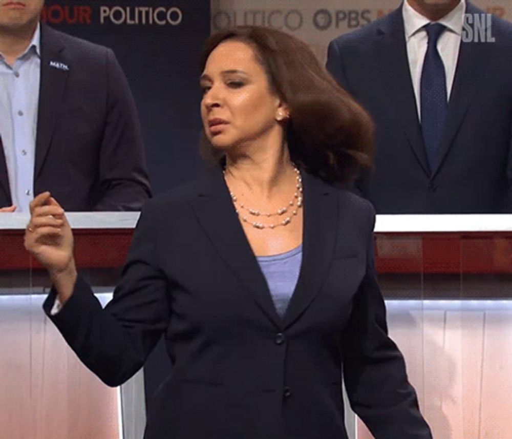 a woman in a suit and tie stands in front of a sign that says " your politico "