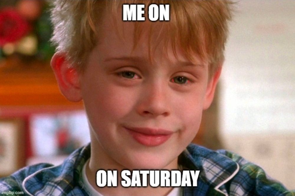 The boy, eyes bloodshot, smiling his iconic smile. The words 'Me on on Saturday' appear in impact font above & below the boy's face