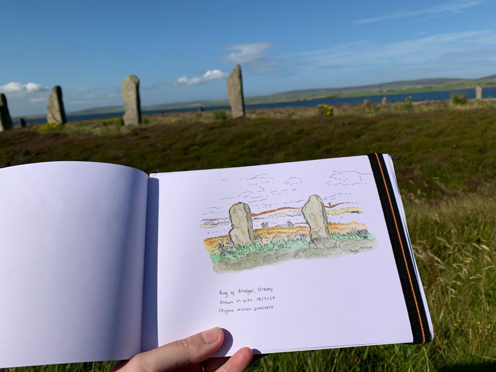 Pen and watercolour sketch of standing stones at the Ring of Brodgar on a fine day with the actual scene in the background.