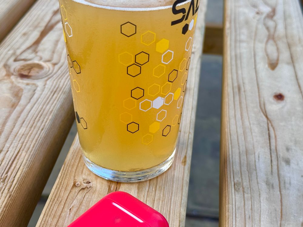 A pint on a table with a hexagonal pattern printed on the side.