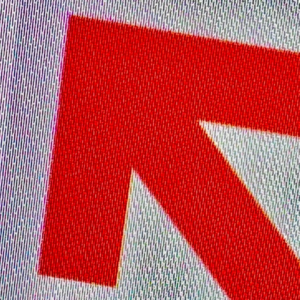 A red arrow shape facing north west on a white background.