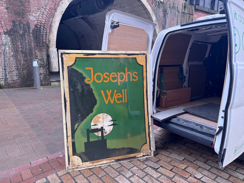 The sign being loaded onto a van.