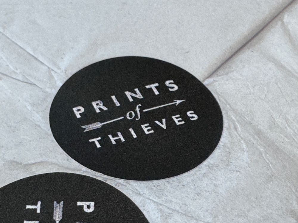 Prints of Thieves black sticker.