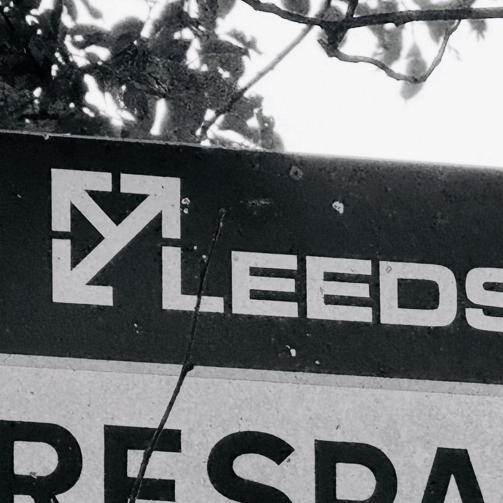 Sign with the old Leeds Motorway City of the Seventies council logo on it.