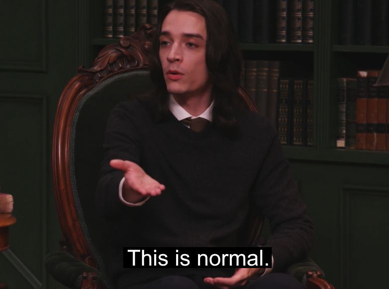 A screenshot of Phil Jamesson on Dropout's panel show Smartypants, wearing a black sweater and commenting on something in front of him saying "This is normal." (it probably isn't)