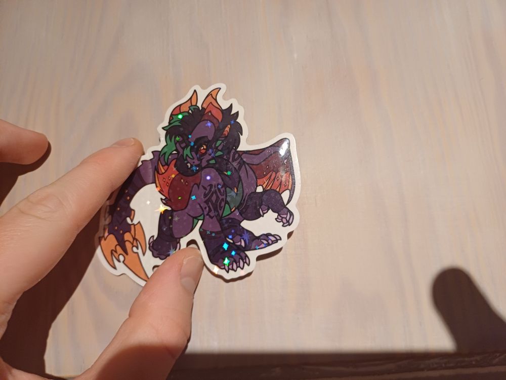 Holographic Sticker of Thlayli - a purple dragon (absolutely gorgeous design btw)