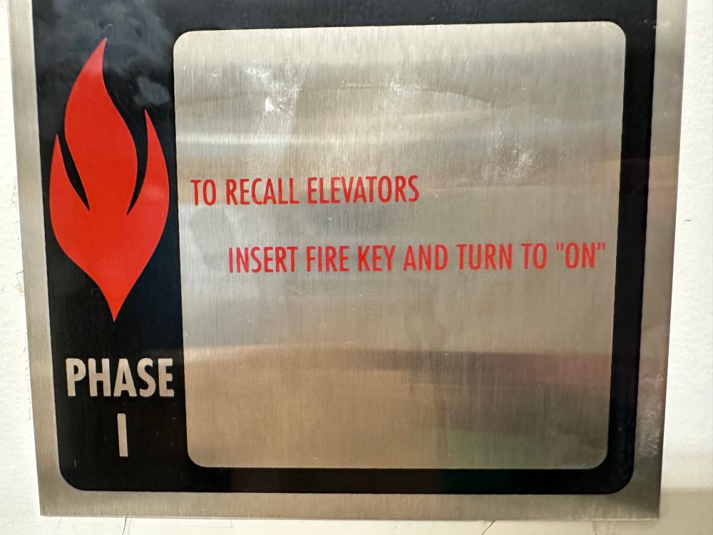 Sign reading “TO RECALL ELEVATORS
INSERT FIRE KEY AND TURN TO ‘ON’”