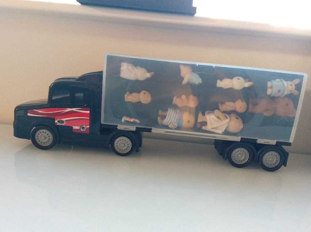 plastic toy truck with Sylvanian puppets stowed in the compartments.