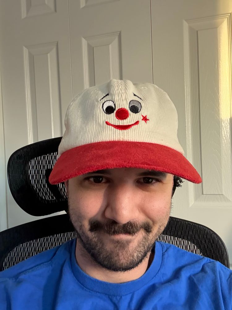 gay guy wearing a bob baker marionettes hat