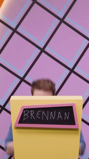 a man stands behind a podium that says brennan on it