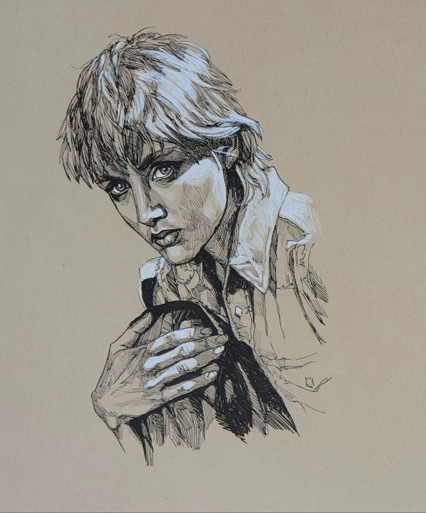 Portrait of a young woman with short blond hair hugging her knee while looking at the camera.