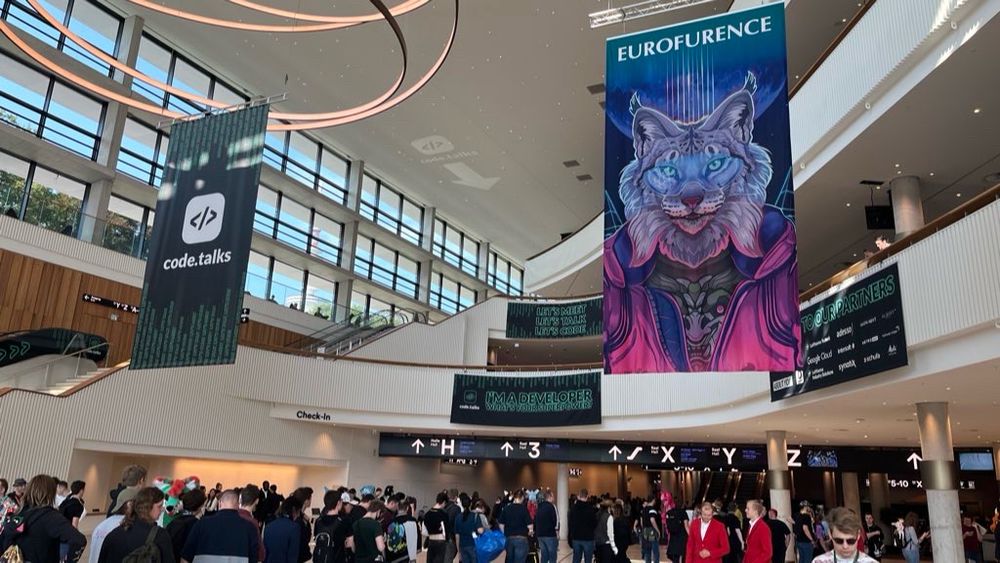 Photograph of entrance of Congress Center Hamburg, showing two banners hanging, one on the left is code.talks, and the one on the right is Eurofurence.