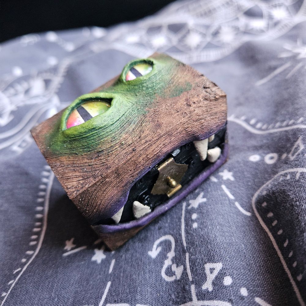A small wooden box with eyes and teeth 