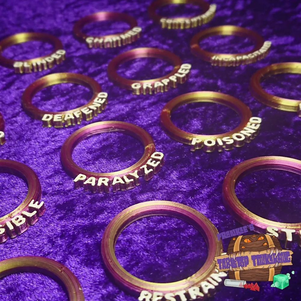Pink rings with conditions written on them such as palaysed, poisoned, grappled