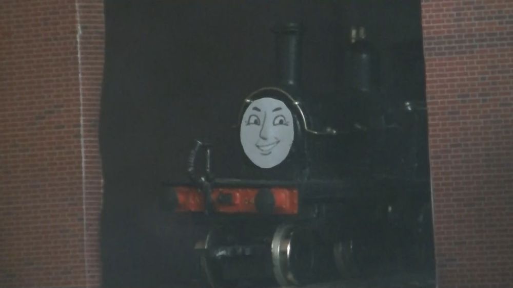 A model of an NBR R/LNER D51 in plain black sat in a model of a locomotive shed. She is smiling. Oh yeah she has a face. That is how she is smiling.

Her name is Sunny, short for Sunnyside - the locomotive's original name during the Drummond Years (presented by Jon Pertwee). Sunny was due to appear in the original series at one point and was a Very Important Plot Point. She was Holmes' mentor and Maude's friend and she went missing (cutting short the already and STILL shamefully small female engine cast of this stupid series - I'm working on it, okay?). Anyway yeah there is an idea from that storyline that I like the concept of and want to use at some point but we'll see how far we get, eh?