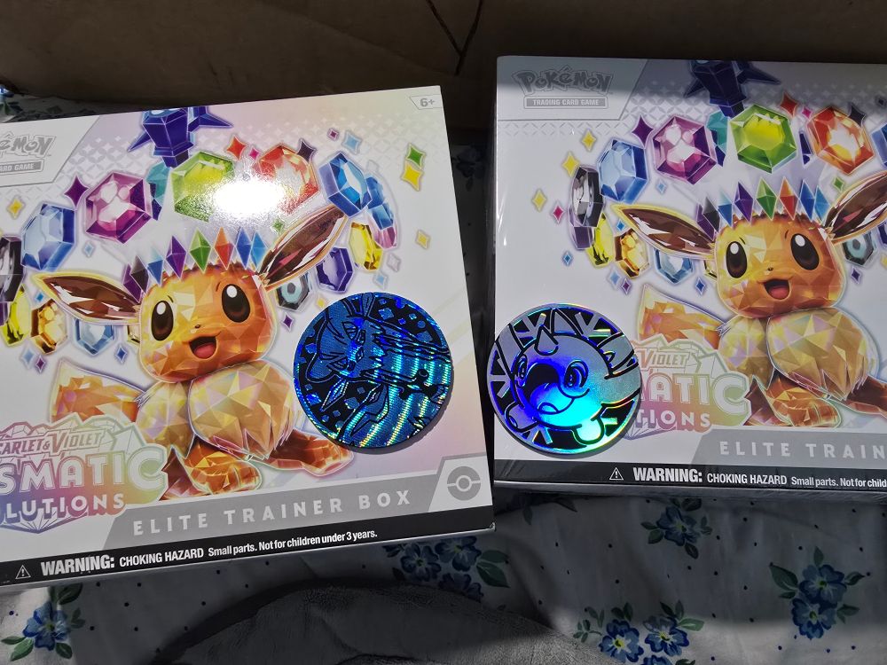 Two prismatic evolutions elite trainer boxes, there's a chien pao and cetoddle coin on each