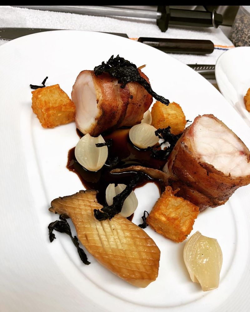 Bacon wrapped monkfish, duck fat tots, king oyster & black trumpets, confit onion, tamarind glacé