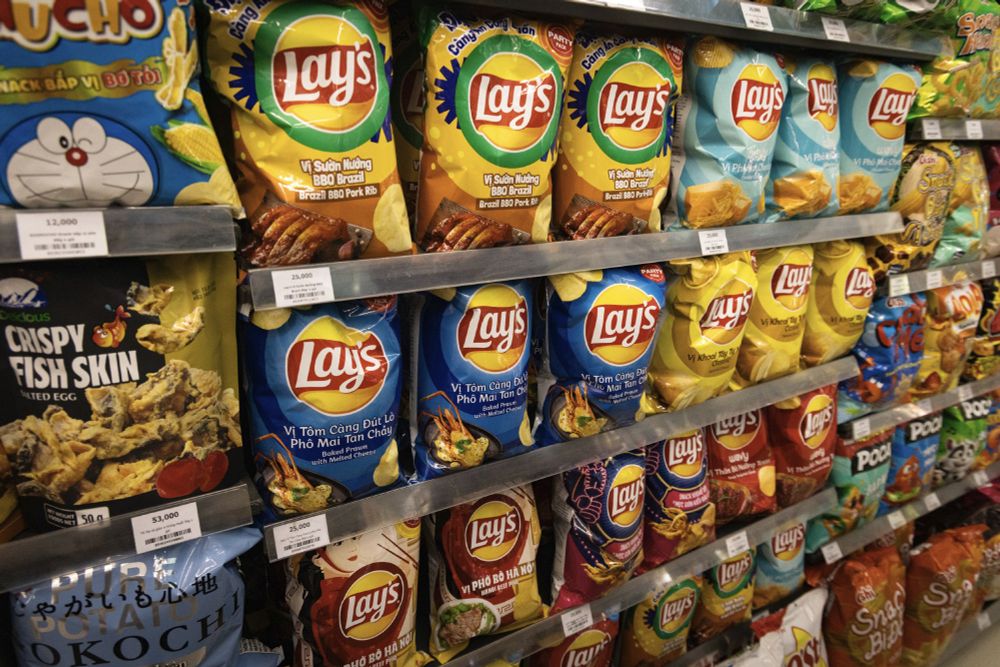 Chip aisle in a Vietnamese bodega. Lay's flavors include: Brazilian BBQ, baked prawn with cheese, Hanoi beef pho