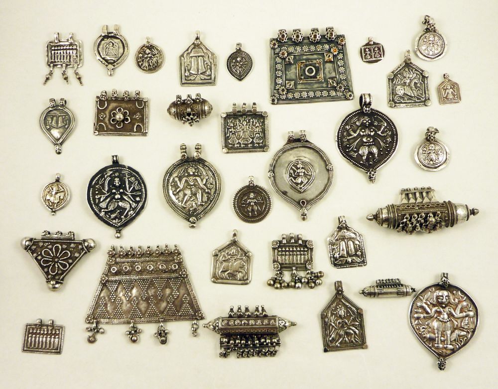 A collection of silver amulets