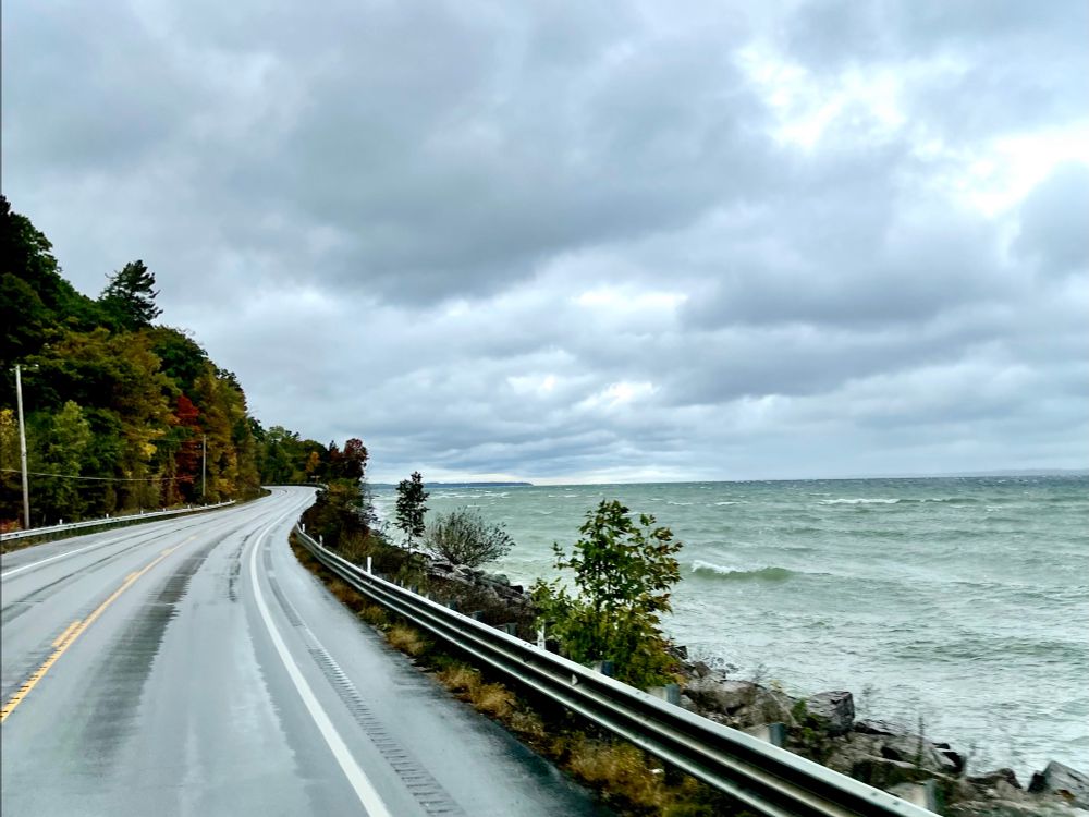 A Lake Michigan shoreline road with thunderclouds and waves forming.