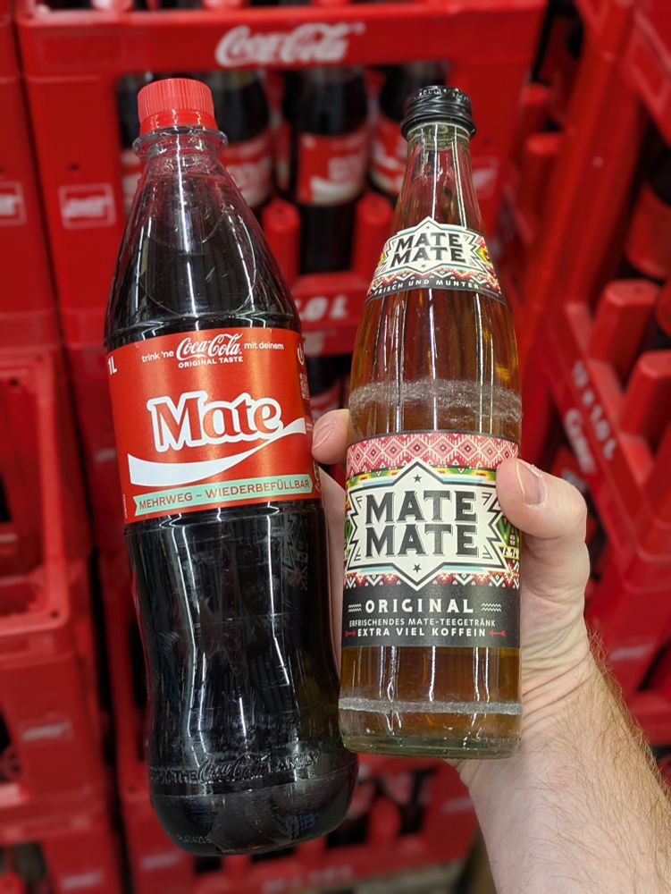 Two bottles, one of "Mate Mate" the other of Coca-Cola with the word "Mate".

Which might mean a South American tea... though the other Coke bottles had words like "Family", "Friend"... written on them. 